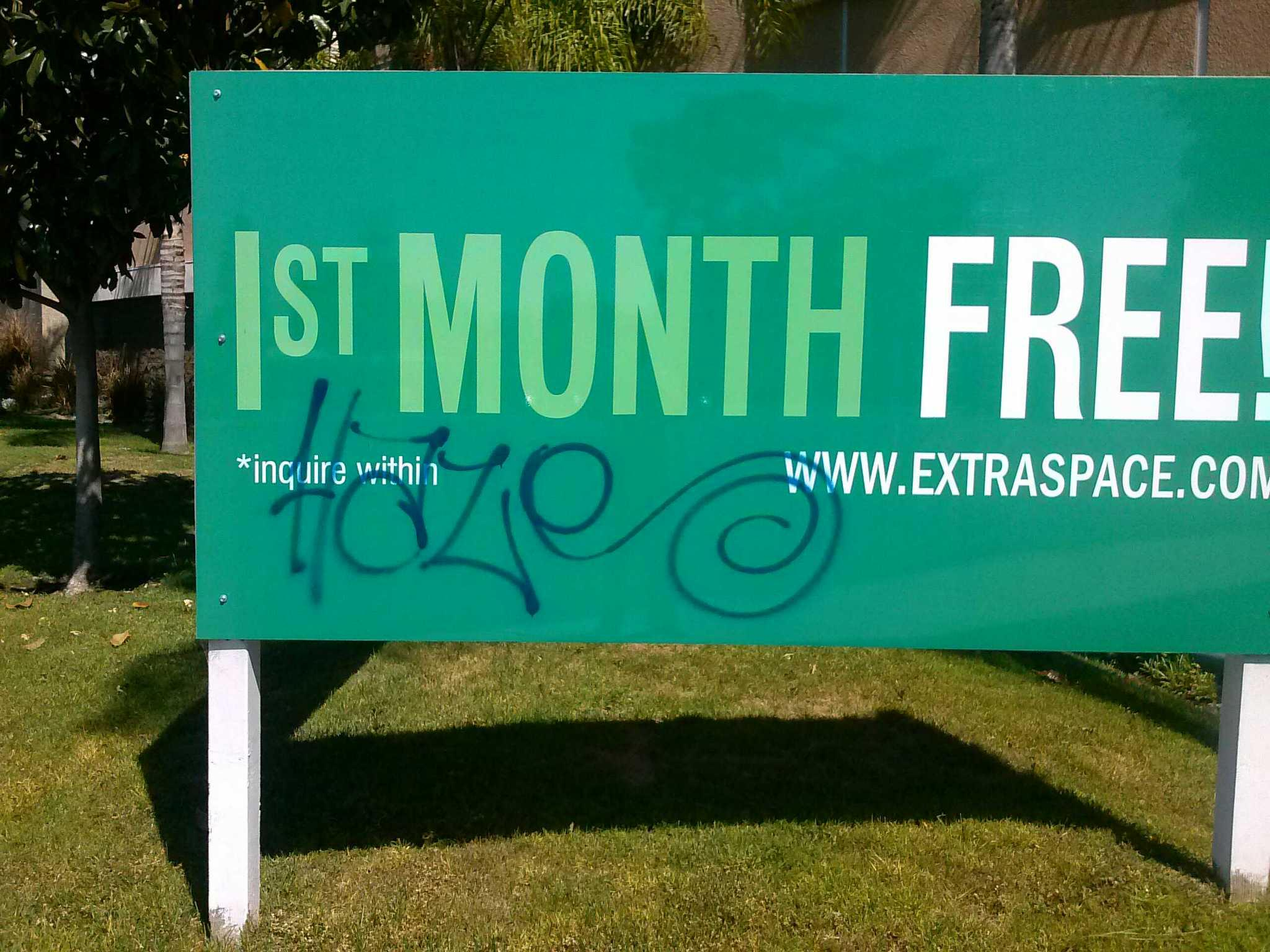 Instant Signs Cypress sign tagged with graffiti before cleaning